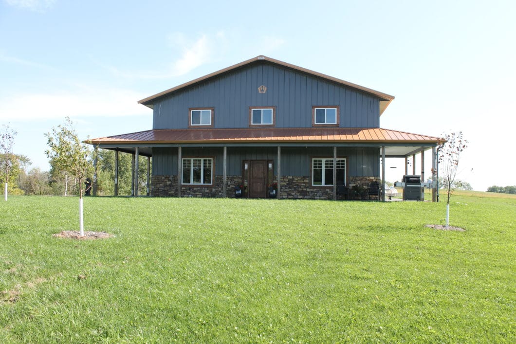 pole barn house with wrap around porch